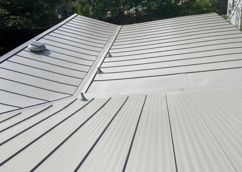 Solar attic fan installed on a metal roof for Roof Ventilation in Bath